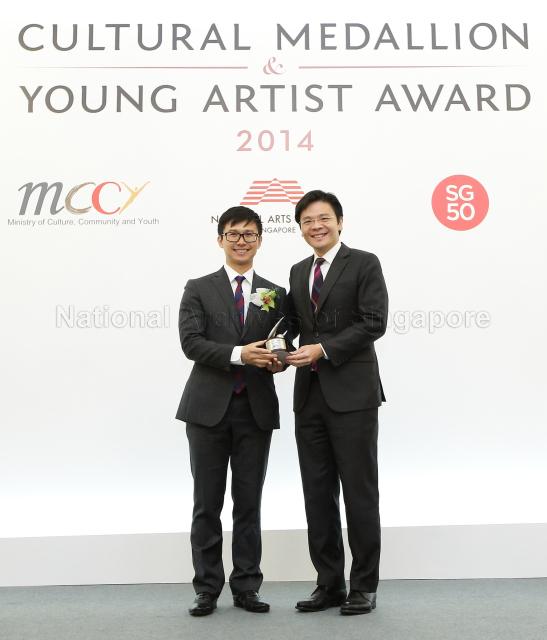 Minister for Culture, Community and Youth Lawrence Wong presenting the Young Artist Award to Chen Zhangyi at the 2014 Cultural Medallion and Young Artist Award presentation ceremony