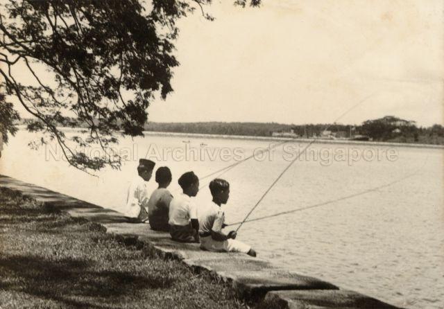 Malay boys fishing at the Johore River