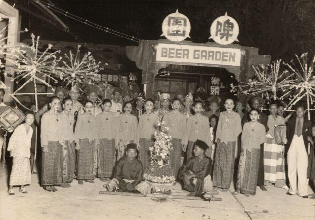 Malay Procession Wedding Party posing in front of a Beer Garden