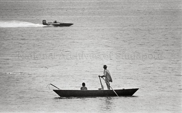 A modern motorboat roaring past a sampan