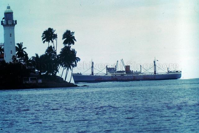 A ship anchored beside the Raffles Lighthouse.