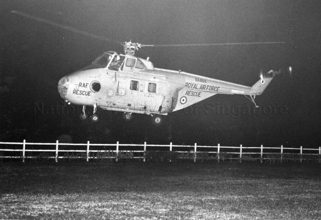 Photograph of a 103 Sqn Whirlwind, XR484, taking off from the lawn fronting the mess and departed for Changi, at 20:20 hours on March 28th 1969, after which the airfield lights were symbolically switched off in groups. The rest of the squadron were already at Changi. A reception was held in the Officersâ€™ Mess to mark the end of Seletarâ€™s role as a flying station.