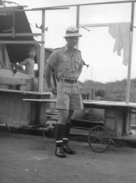Photograph of a Singapore policeman in full uniform.