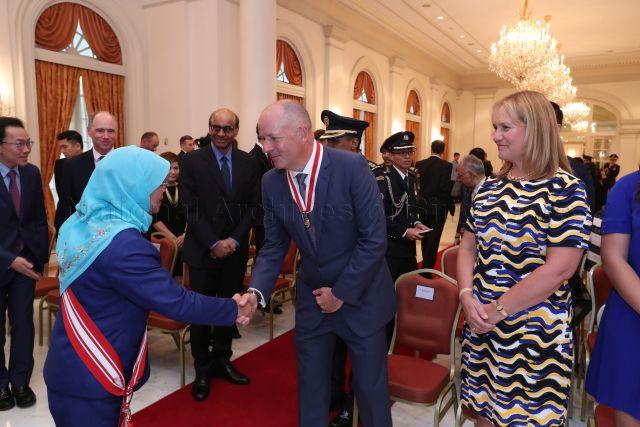Taken at: Conferment of Honorary Citizen Award to Sir Andrew Philip Witty at the Istana  Pictured: President Halimah Yacob, Deputy Prime Minister and Coordinating Minister for Economic and Social Policies Tharman Shanmugaratnam, Economic Development Board (EDB) Chairman Beh Swan Gin, British High Commissioner to Singapore Scott Wightman and former Chief Executive Officer of GlaxoSmithKline (GSK) Sir Andrew Witty and his wife Lady Caroline Witty