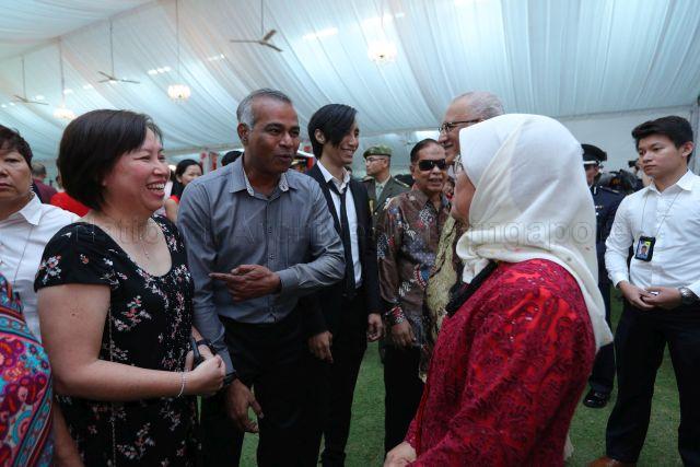 Taken at: National Day reception hosted by President Halimah Yacob at the Istana Pictured: President Halimah Yacob and her husband Mohamed Abdullah Alhabshee, father-and-son busking duo Mashruddin Saharuddin and his son Nizaruddin, and founder of green design firm Greenology Veera Sekaran