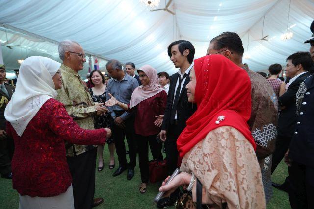 Taken at: National Day reception hosted by President Halimah Yacob at the Istana Pictured: President Halimah Yacob and her husband Mohamed Abdullah Alhabshee, father-and-son busking duo Mashruddin Saharuddin and his son Nizaruddin, and founder of green design firm Greenology Veera Sekaran