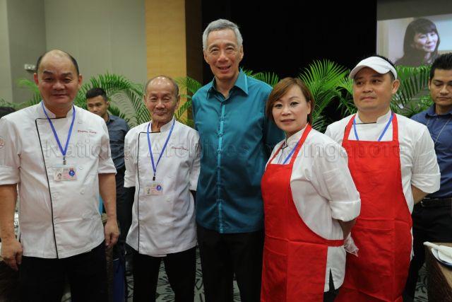 Taken at: National Day Rally 2018 and reception at ITE College Central Pictured: Prime Minister Lee Hsien Loong, Chicken Rice @ Our Tampines Hub owner Raymond Kiang, his father Sergeant Kiang, sister Susan and staff Wong Sen Chung