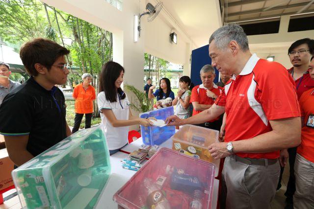 Taken at: Ang Mo Kio (AMK) GRC and Sengkang West (SKW) SMC Family Carnival and Tree Planting Day in front of Block 405A Fernvale Lane in Sengkang  Pictured: Prime Minister Lee Hsien Loong and Member of Parliament for AMK GRC Ang Hin Kee