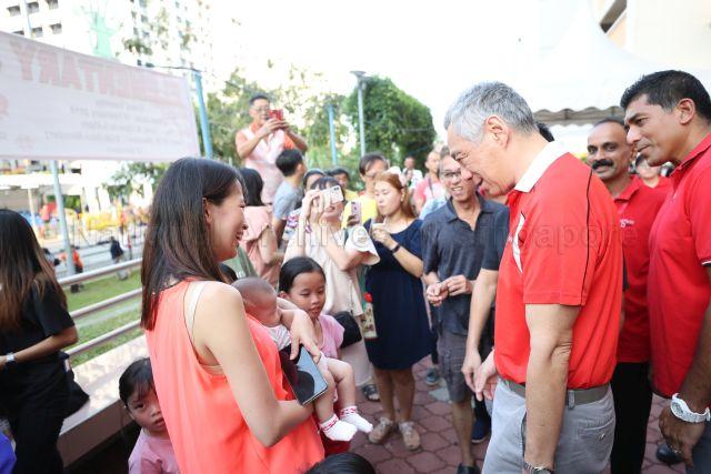 Taken at: Ang Mo Kio-Hougang Chinese New Year Street Parade 2019 Pictured: Prime Minister Lee Hsien Loong and Member of Parliament for Ang Mo Kio Group Representative Constituency (GRC) Darryl David