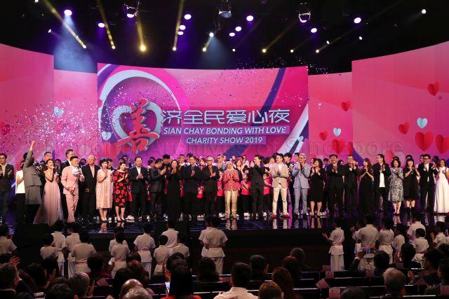Taken at: Sian Chay Bonding With Love Charity Show 2019 by Sian Chay Medical Institution at MES Theatre at Mediacorp Pictured: Guest-Of-Honour President Halimah Yacob, Chairman of Sian Chay Medical Institution Toh Soon Huat and Vice Chairman of Sian Chay Medical Institution Derek Goh Bak Heng