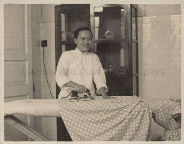 An Amah ironing clothes in house at Avenida Ouvidar Arriaga, Macau