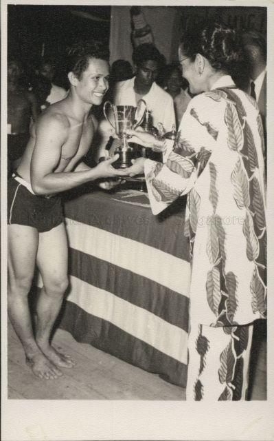 Datin Puteh Mariah presents a cup to the winner of the body building competition at the Fair, Ulu Langat