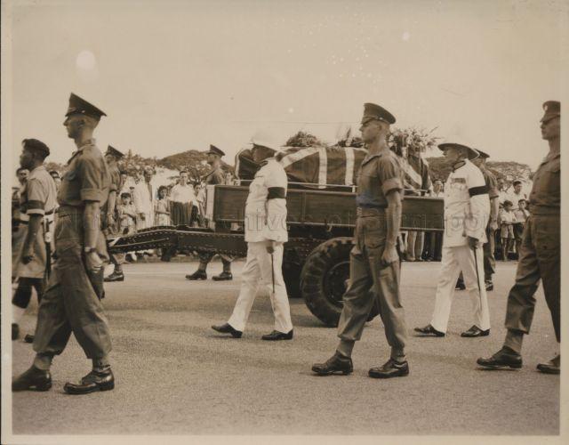 Funeral of His Excellency the new Governor of Sarawak, Mr Duncan Stewart who was attacked and stabbed in Sibu, Sarawak. The gun-carriage bearing the flag-draped coffin was drawn from the Supreme Court building to St. Andrew's Cathedral by a detachment of Malay police, with an escort of Scots Guards