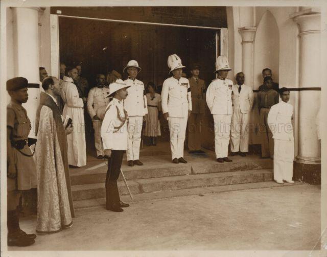 Funeral of His Excellency the new Governor of Sarawak, Mr Duncan Stewart who was attacked and stabbed in Sibu, Sarawak. Duncan Stewart's coffin enters St Andrew's Cathedral. From left, Archdeacon Gregory, Captain P.A. Heslop, and pall bearers Mr C.W. Dawson, O.A.G Sarawak, Mr P.A.B Mc Kerron, O.A.G. Singapore, and Sir Henry Gurney, High Commissioner, Federation of Malaya.