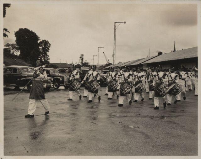 A slow march played by the Singapore Police Band as Governor of Singapore, Sir Franklin Gimson returns to Singapore from leave.