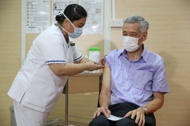 Taken at: Covid-19 vaccination at the Singapore General Hospital (SGH) Pictured: Prime Minister Lee Hsien Loong and senior staff nurse Fatimah Mohd Shah