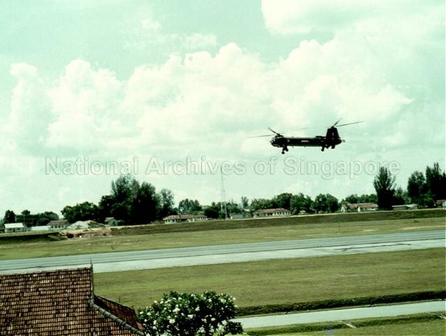 Photograph of Bristol Belvedere helicopter, of No. 66 Squadron, in flight over Seletar Camp
