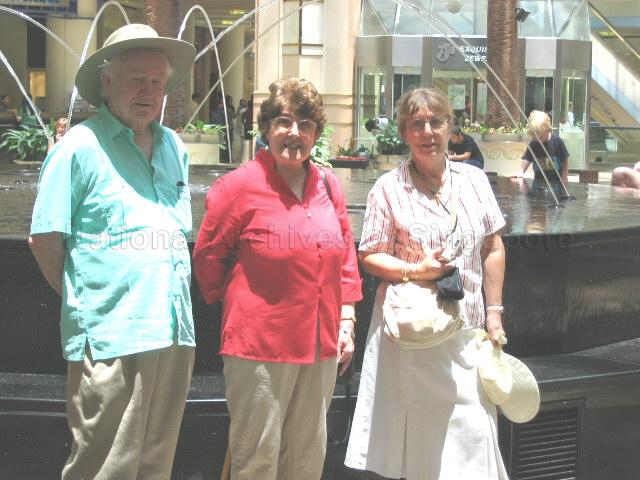 Photograph of Royal Air Force Seletar Association (RAFSA) visitors posing in front of a fountain in the Raffles City shopping centre