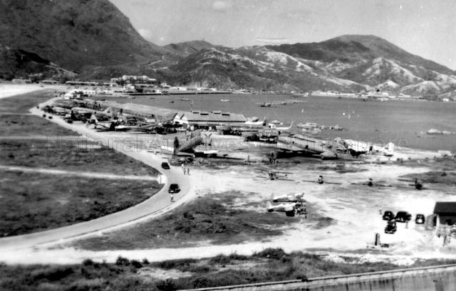 Aerial view of Royal Air Force (RAF) Kai Tak Station, Hong Kong. Three Sunderland flying boats, of No. 88 Squadron at moorings.
