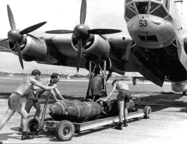 Photograph of airmen loading bombs into Avro Lincoln aircraft.