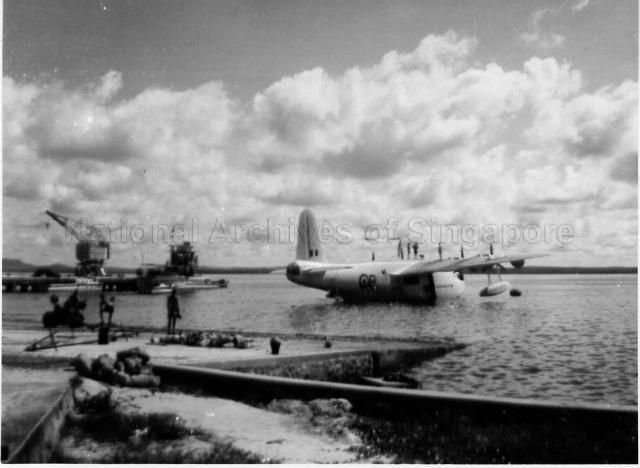 Short Sunderland flying boat, ML797 'P' Papa, of No. 205 Squadron, being hauled out of the water for the last time at Royal Air Force (RAF) Seletar. She would be winched up the slipway, stern first past an honour guard who would present arms. The aircraft was flying a paying-off pennant with the 205 Squadron flag (crossed kris) on display. On 14 May 1959, Sunderland DP198 'W' Whisky, made its last maritime operational sortie by escorting HMS Caprice through the Malacca when it was on its way from Ceylon to Singapore. On 15 May 1959, DP198 'W' and ML797 'P' made a farewell flypast over Singapore. On 20 May 1959, ML797 'P' was allotted the honour of making the very last flight of an RAF Sunderland. Both flying boats were struck off charge at Changi on 29 July 1959 and scrapped at the base.
