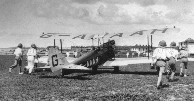 Photograph of typist turned aviatrix Amy Johnson arriving at Singapore's only airport in 1930, the joint military/ civil facility at Seletar. Her aircraft the DH Gipsy Moth G-AAAH which she named Jason.