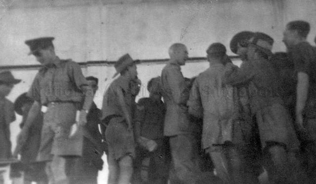 Photograph of Air Vice Marshal Sir Keith Park addressing a meeting of the strikers by airmen in the flying boat hangar. The strike arose due to the slow rate of repatriation to the U.K. after war, unsuitable living conditions and poor food.