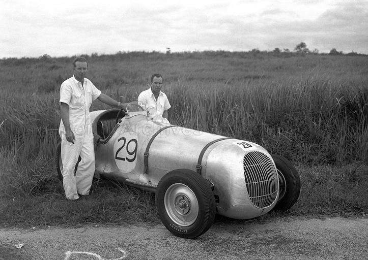 J N K (known as "Neil") Moncrieff (left) and Roy Kendall posing for a photograph with their Kudensay during a half-mile standing start speed event organised by Singapore Motor Club at Lim Chu Kang. They called the jointly owned vehicle Kudensay due to the many and varied parts they had used to build the car. 