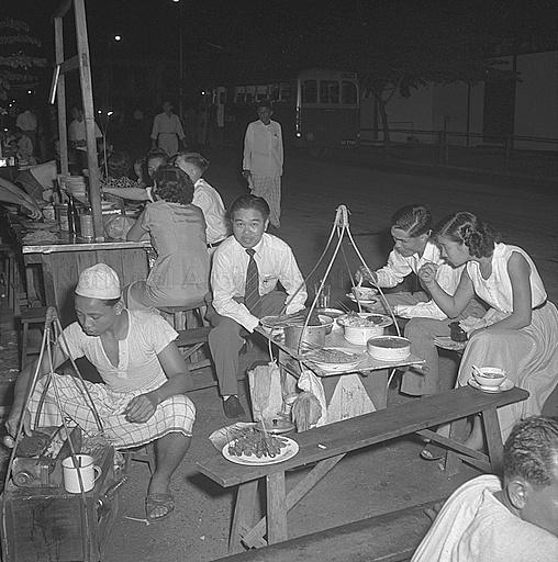 A street hawker stall selling satay opposite the bus terminal at Beach Road