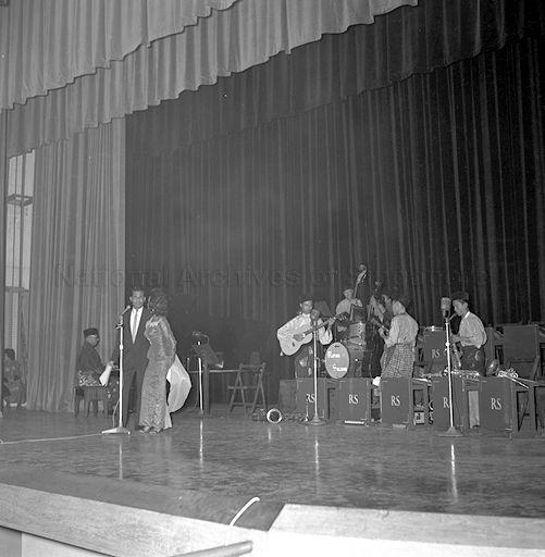 Ahmad Daud and Saloma performing a song backed by Combo Rayuan Sukma and Mohd Wan Yet at the piano during Radio Singapore mammoth Christmas show at Victoria Theatre. 