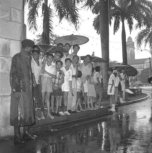 Spectators Brave the Heavy Rain during Singapore's first National Day Mass Rally and March-past at the Padang