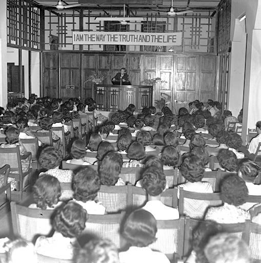 View of service at Bethesda (Katong) Church at junction of Carpmael and Pennefather Roads. Foundation stone for this Brethren church was laid on 11 November 1935 by Mrs Wee Thiam Seng, wife of banker who donated the land on which it still stands and grandmother of Mrs Lee Kuan Yew. Completed at end of 1936, it is the first "branch" of the Brethren church in Singapore, the first main church being Bethesda Chapel at 77 Bras Basah Road. The history of the Brethen church here can be traced back to the mid 19th century when Philip Robinson, co-founder of Robinson and Company, first arrived.
