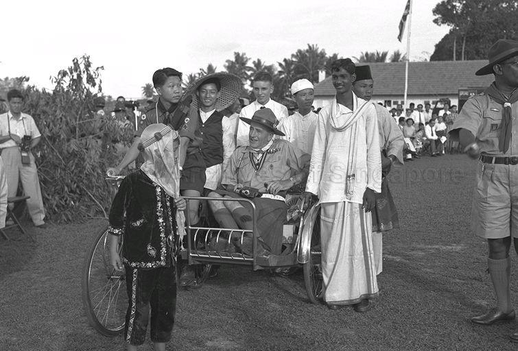Tommy Koh of 02 Raffles Scout Group riding trishaw carrying