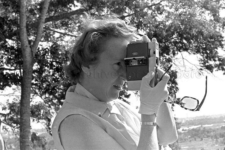 Lady Ruth Khama, wife of President of Botswana Sir Seretse Khama, taking photographs of Singapore from Mount Faber Hill. The spouses of Commonwealth delegates are on a sightseeing tour of Singapore, while the delegates attend the Commonwealth Heads of Government Meeting (CHOGM).