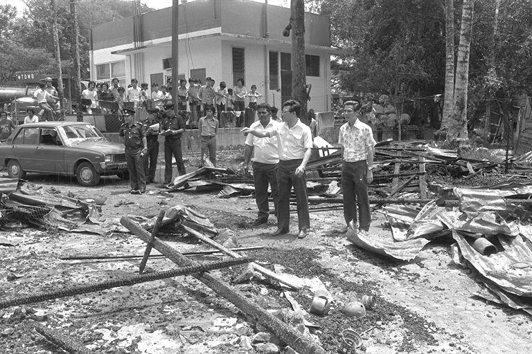 Member of Parliament for Bukit Panjang Lee Yiok Seng (second from right) visiting the fire site at the junction of Woodlands Road and Stagmont Ring behind the petrol kiosk.